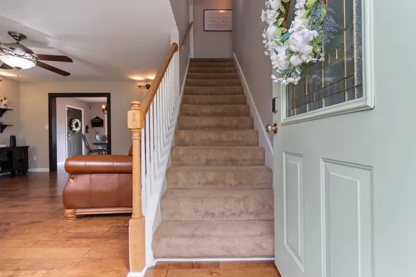 a view of entryway and hall with wooden floor