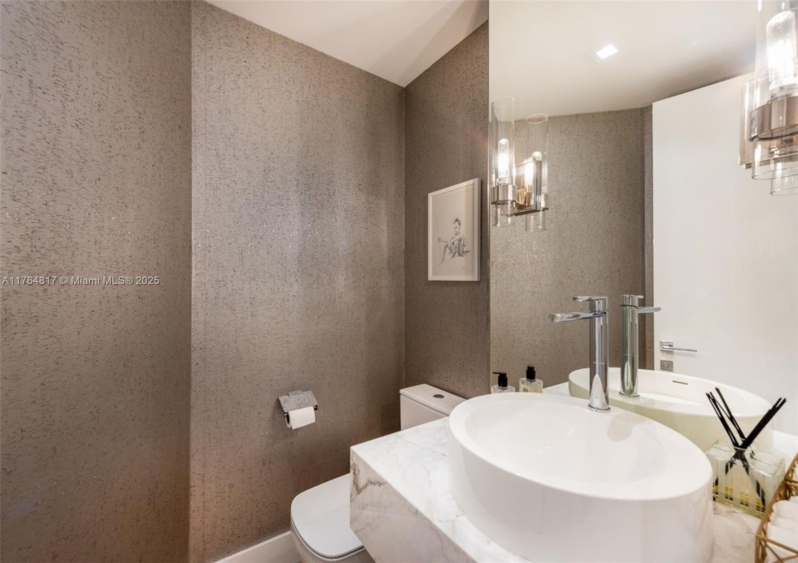 888 Brickell Key Drive, Unit 2501 Miami, FL 33131 - Photo 12 of 39 a bathroom with a sink a toilet and mirror