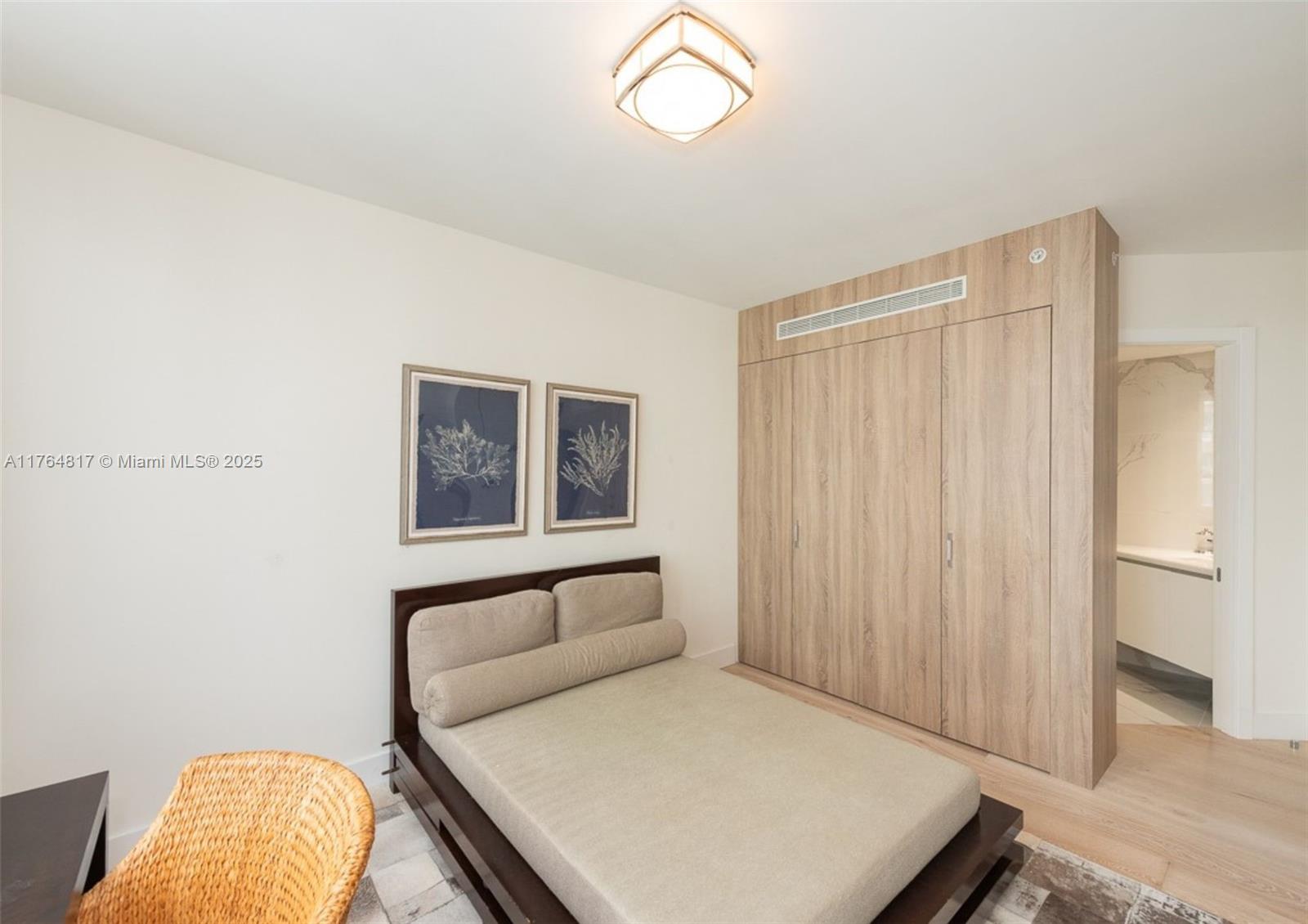 888 Brickell Key Drive, Unit 2501 Miami, FL 33131 - Photo 20 of 39 a bedroom with a bed and a window