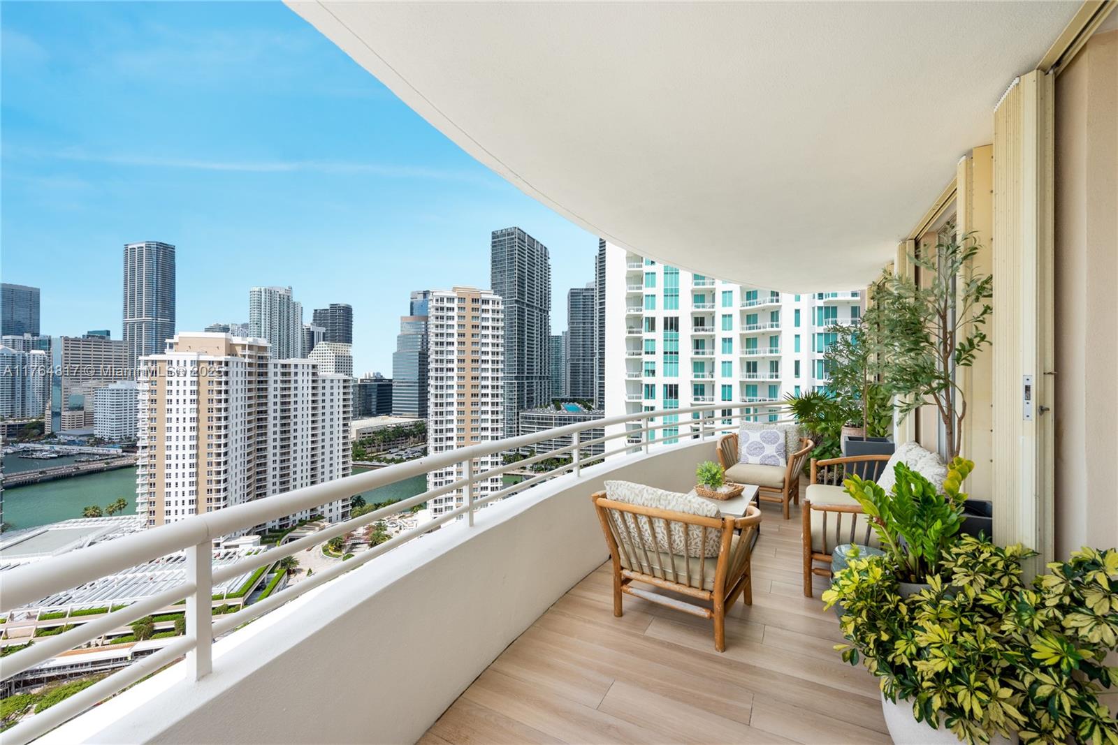 888 Brickell Key Drive, Unit 2501 Miami, FL 33131 - Photo 24 of 39 a roof deck with outdoor seating and city view