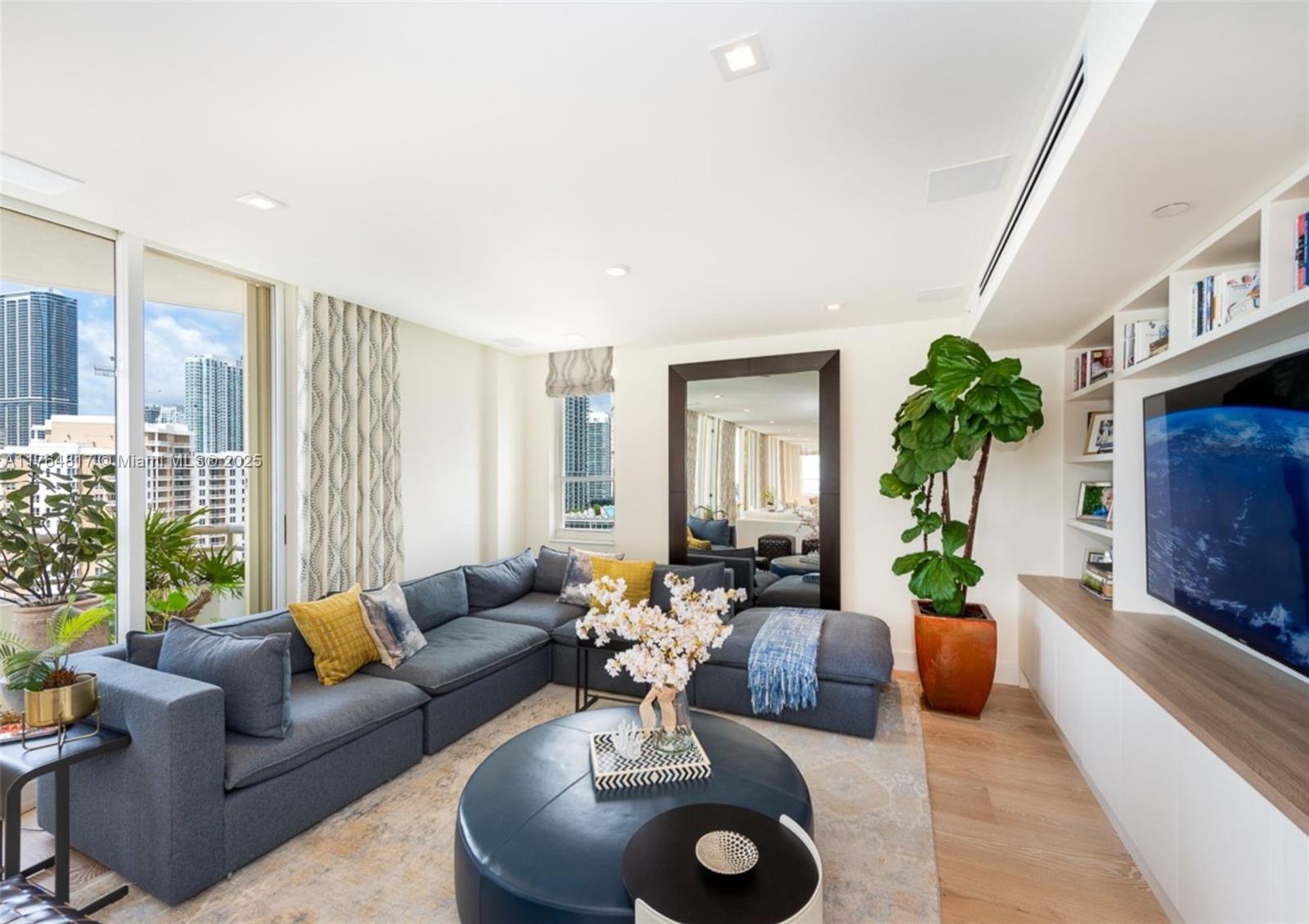 888 Brickell Key Drive, Unit 2501 Miami, FL 33131 - Photo 5 of 39 a living room with furniture potted plant and a large window