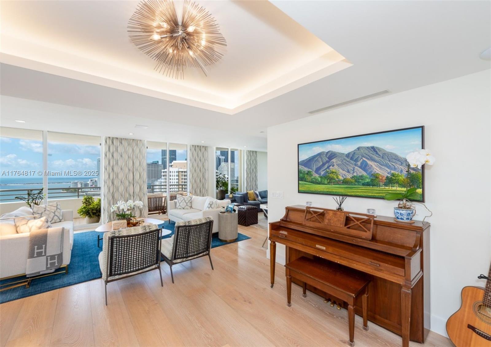 888 Brickell Key Drive, Unit 2501 Miami, FL 33131 - Photo 6 of 39 a living room with furniture and a flat screen tv