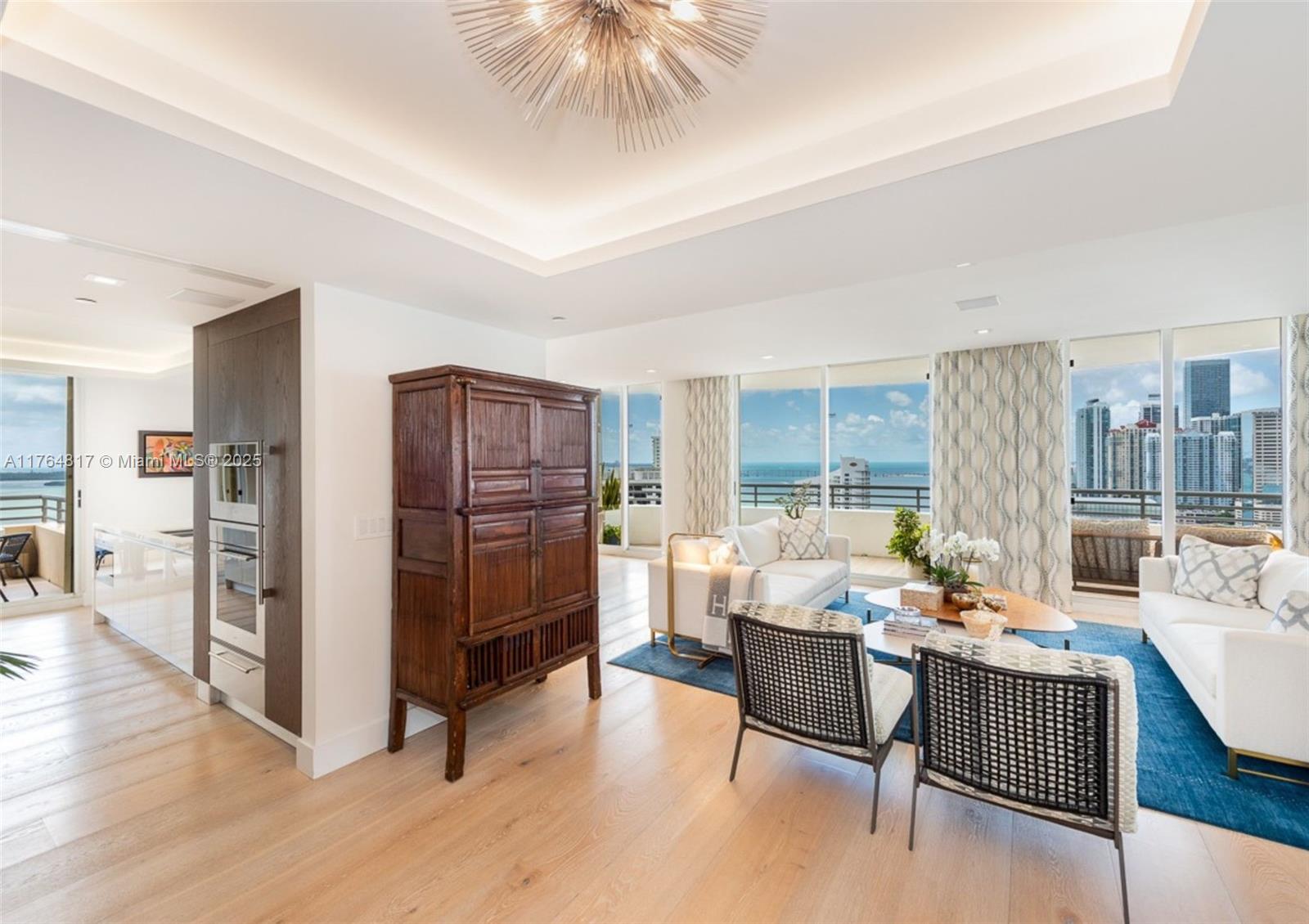 888 Brickell Key Drive, Unit 2501 Miami, FL 33131 - Photo 7 of 39 a living room with furniture and a flat screen tv