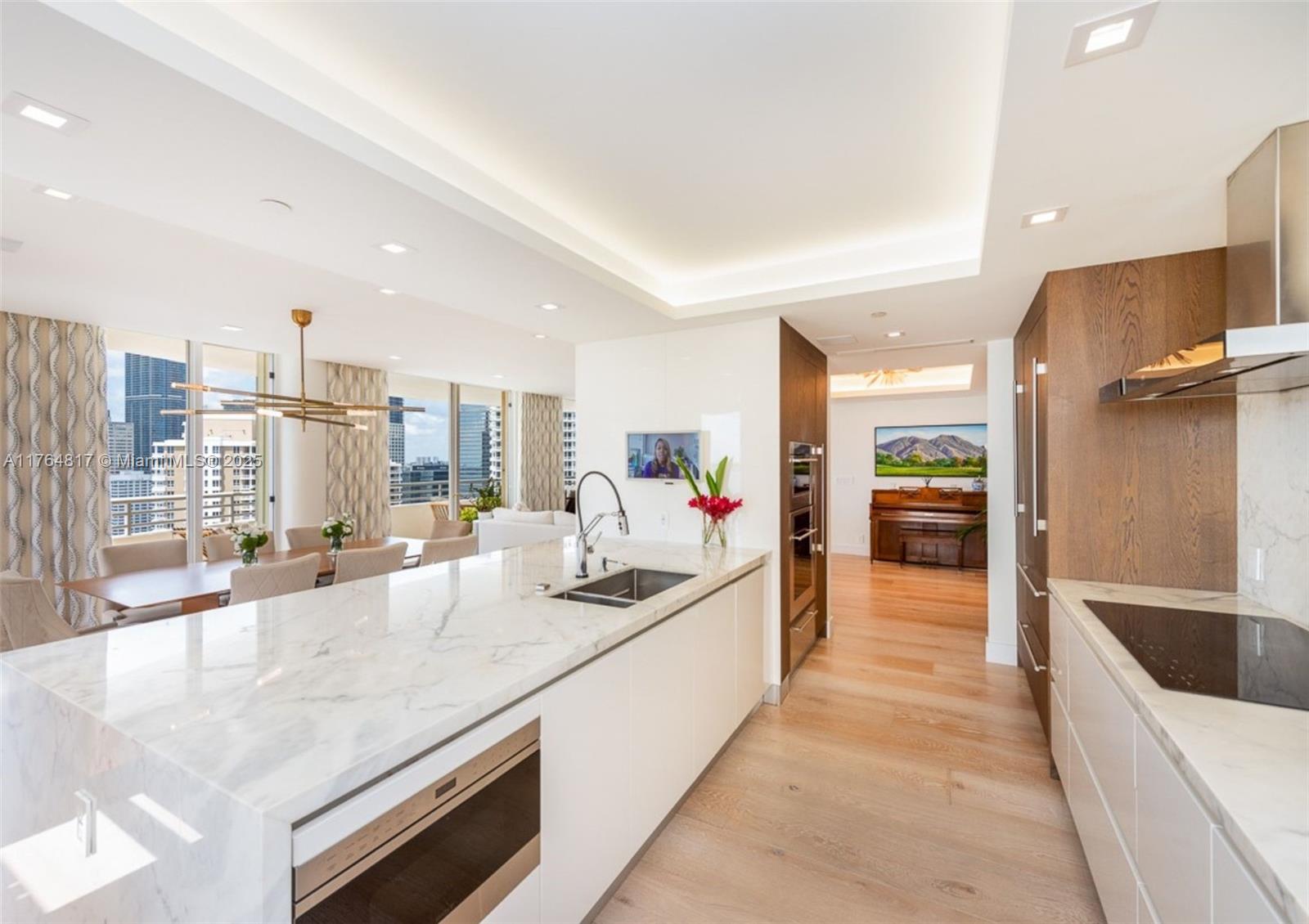 888 Brickell Key Drive, Unit 2501 Miami, FL 33131 - Photo 8 of 39 a large kitchen with granite countertop a large counter top and sink