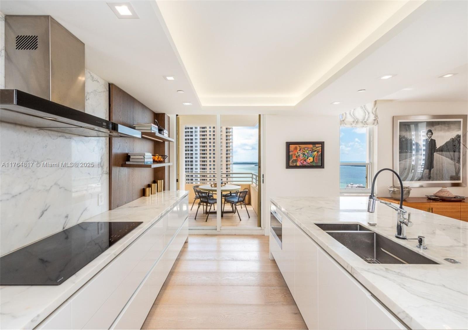 888 Brickell Key Drive, Unit 2501 Miami, FL 33131 - Photo 9 of 39 a large white kitchen with stainless steel appliances a sink and a large window