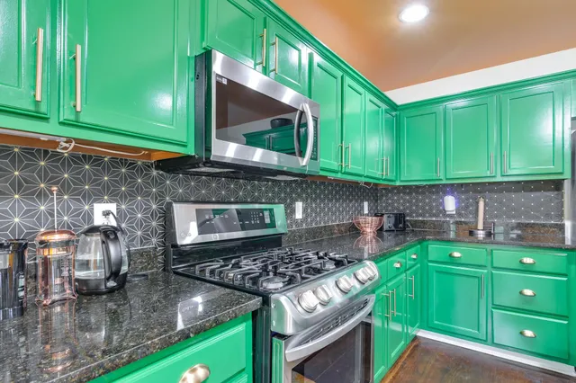 a kitchen with cabinets and a stove top oven