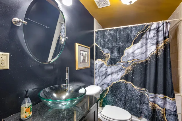 a living room with furniture and a mirror