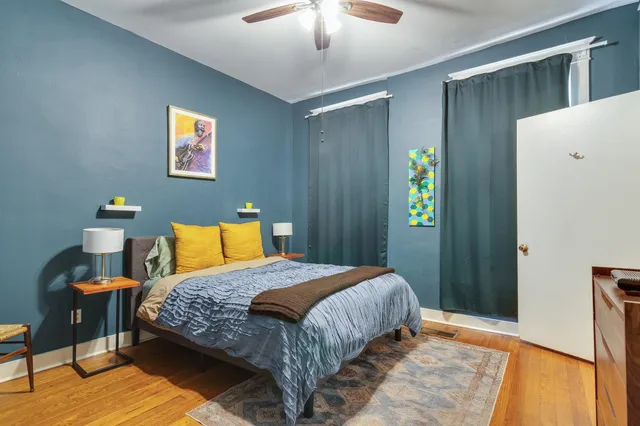 a bedroom with a bed and a chandelier