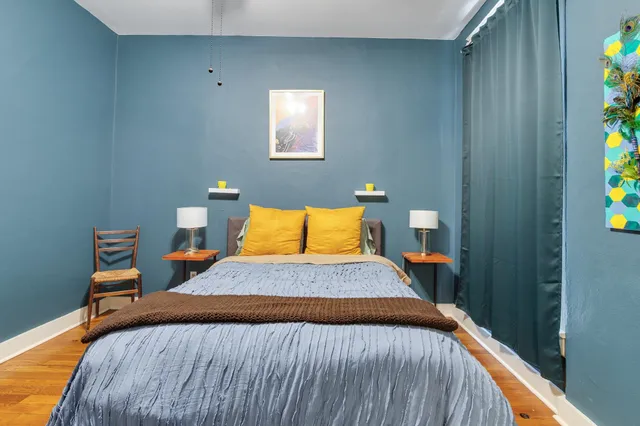 a bedroom with a bed and flowerpot