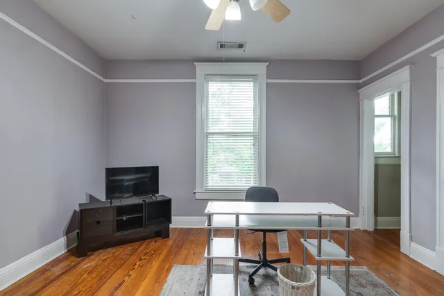 a workspace with furniture window and wooden floor