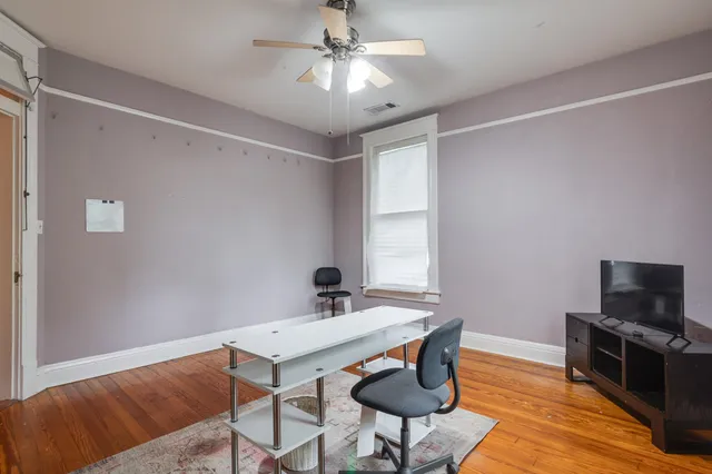 a view of a livingroom with furniture and a window