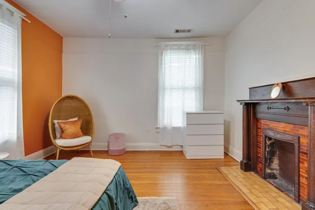 a living room with furniture a fireplace and window