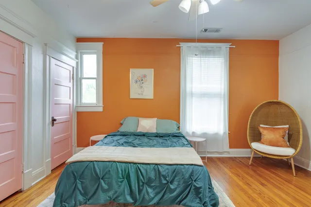 a bedroom with a bed and a chandelier