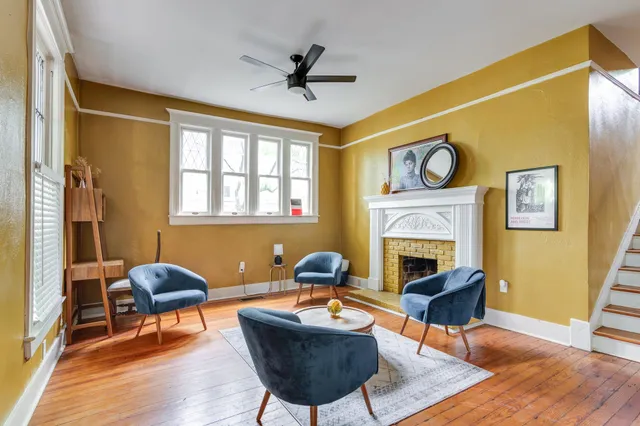 a living room with furniture and a fireplace