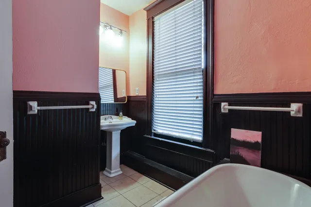 a bathroom with a bathtub and a sink