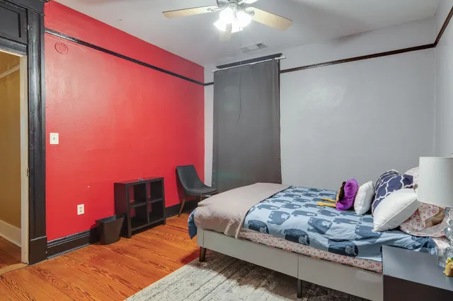 a bedroom with a bed and a chandelier