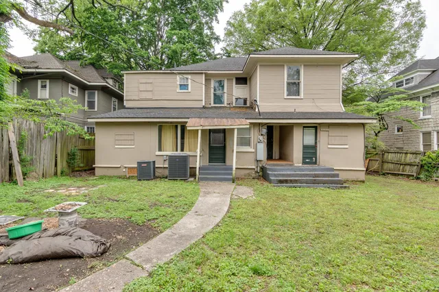 a view of a house with a backyard porch and sitting area