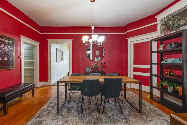 a view of a dining room with furniture and chandelier