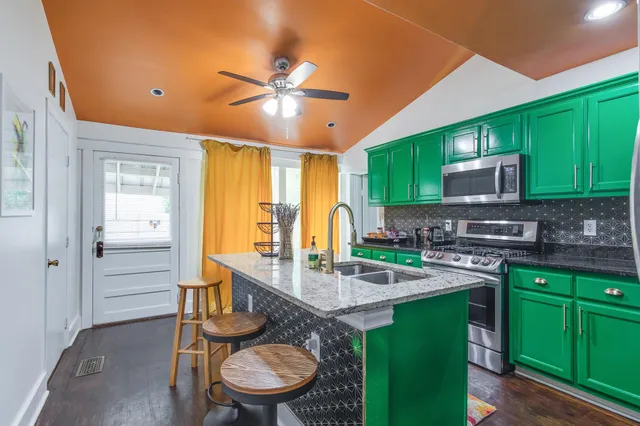 a kitchen with a sink cabinets and appliances