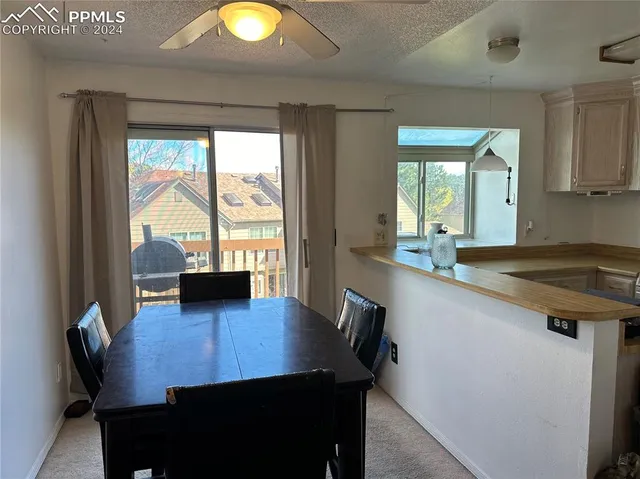 a view of a dining room with a table and chairs