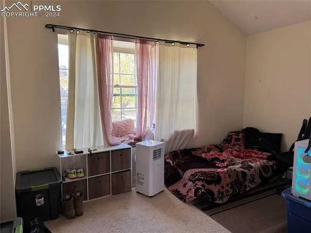 a bed room with furniture and a window