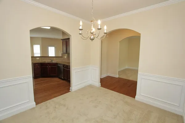 an empty room with windows and fireplace
