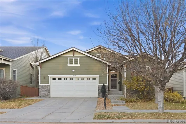 a view of a house with a yard and garage