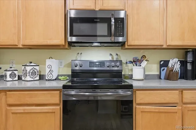 a kitchen with stainless steel appliances granite countertop a sink stove and microwave