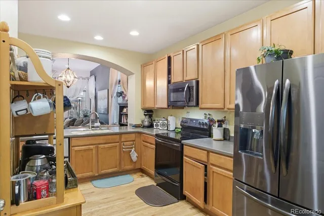 a kitchen with stainless steel appliances granite countertop a refrigerator sink and microwave