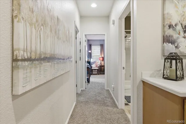 a view of a hallway with wooden shelves