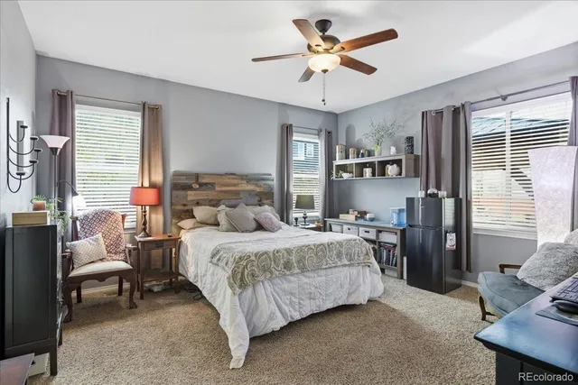 a bedroom with a bed a couch and dresser