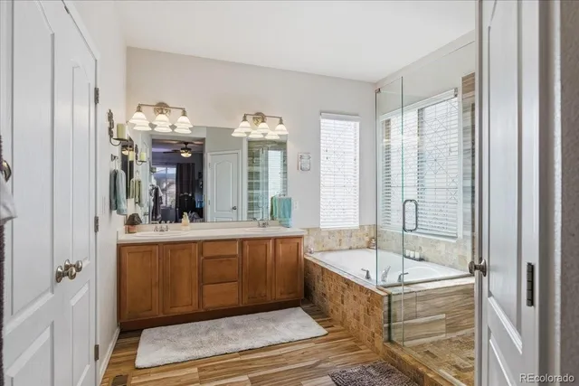 a bathroom with a tub sink and mirror