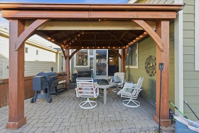 a front view of a house with a tree