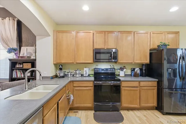 a kitchen with a sink appliances and cabinets