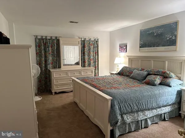 a bedroom with a bed next to a window