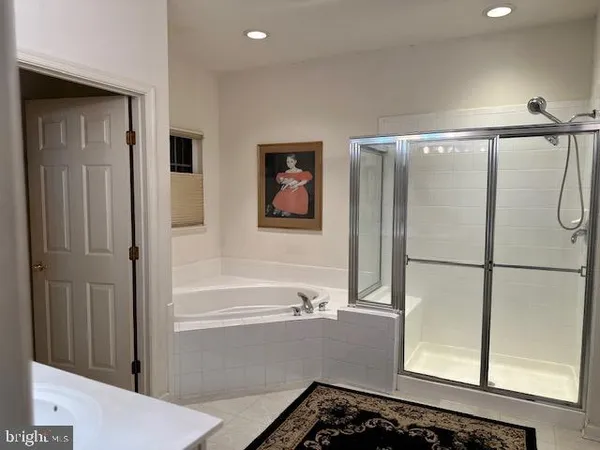 a bathroom with a bathtub and a shower