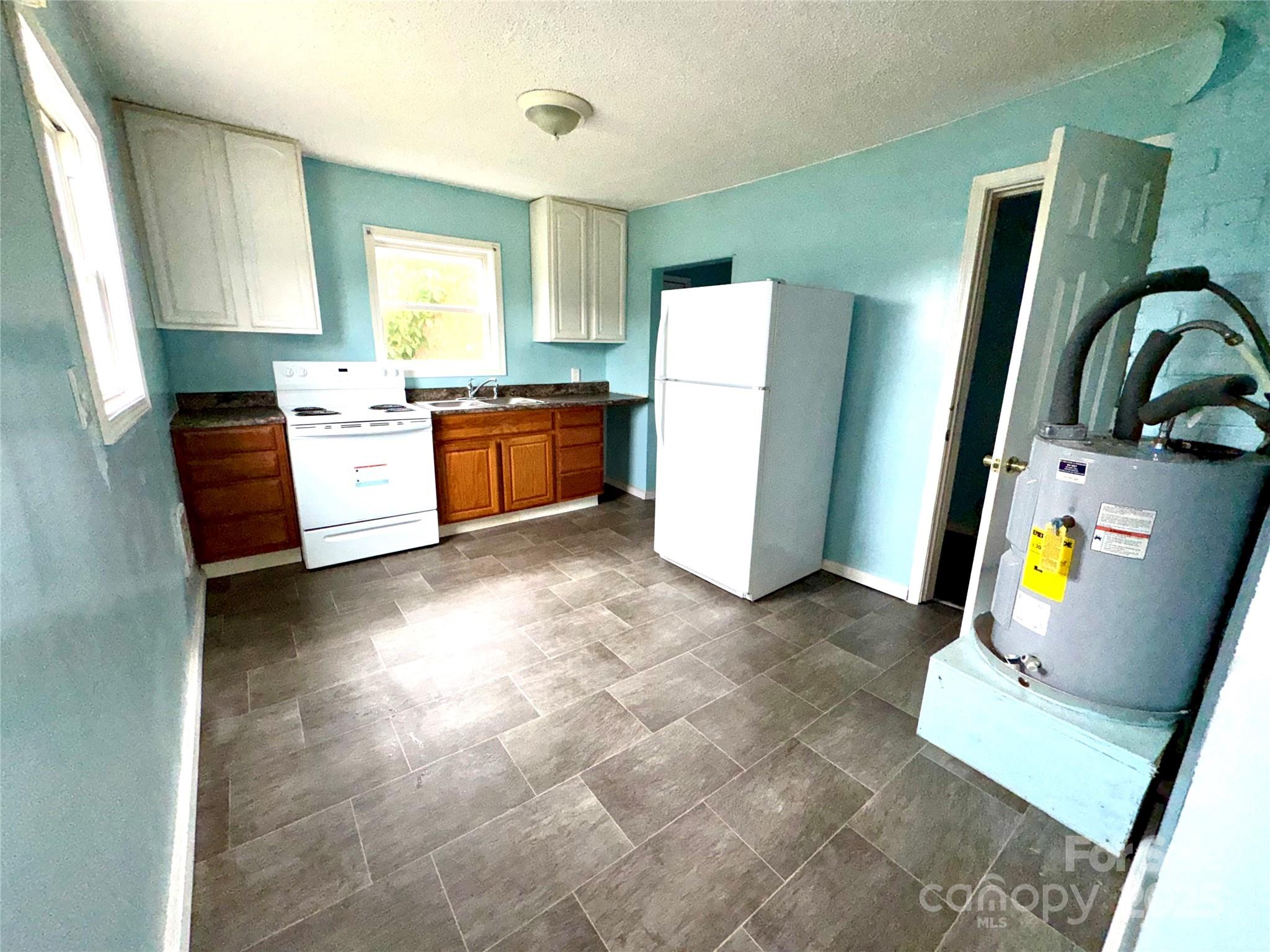 163 Kerr Street Northwest Concord, NC 28025 - Photo 7 of 11 a kitchen with refrigerator and window