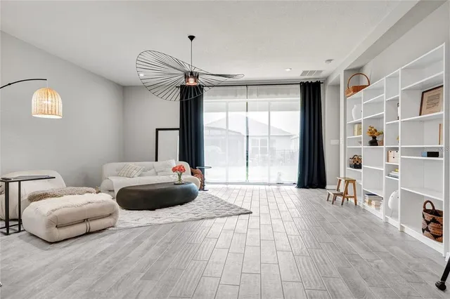 a bedroom with furniture and a large window