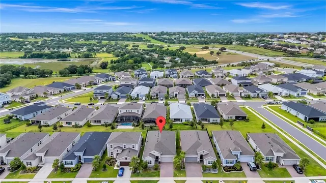 an aerial view of residential building and lake