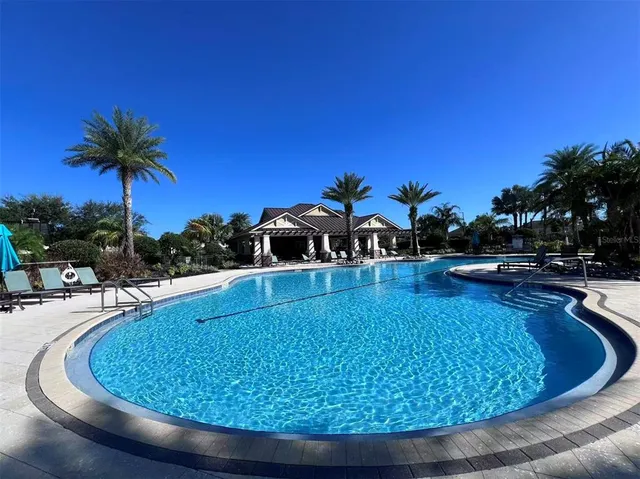 a view of a swimming pool and lounge chairs