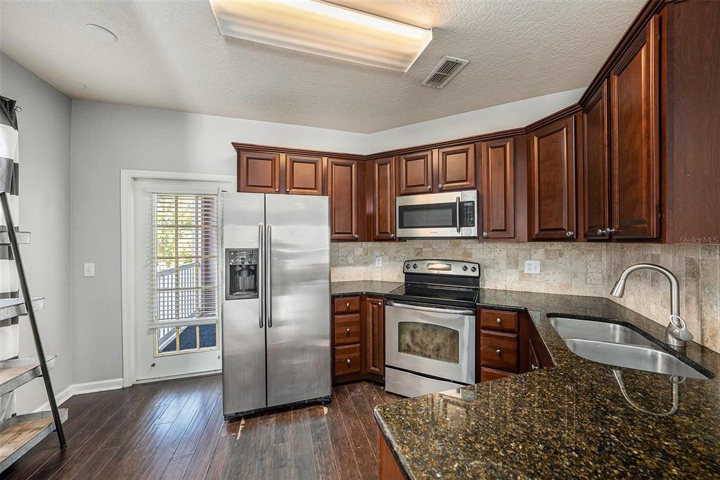 10436 Villa View Circle Tampa, FL 33647 - Photo 8 of 18 a kitchen with stainless steel appliances granite countertop a refrigerator stove top oven and sink