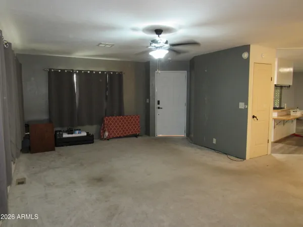 a view of a room with gym equipment and a chandelier