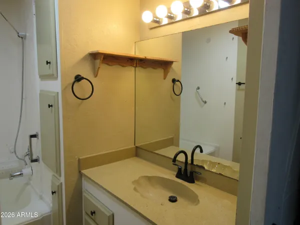 a bathroom with a sink a mirror and shower