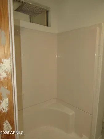a bathroom with a granite countertop sink and a toilet