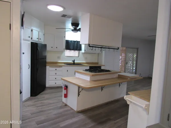 a kitchen with a stove and a refrigerator