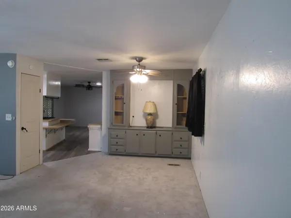 a view of a hallway to a room with a furniture