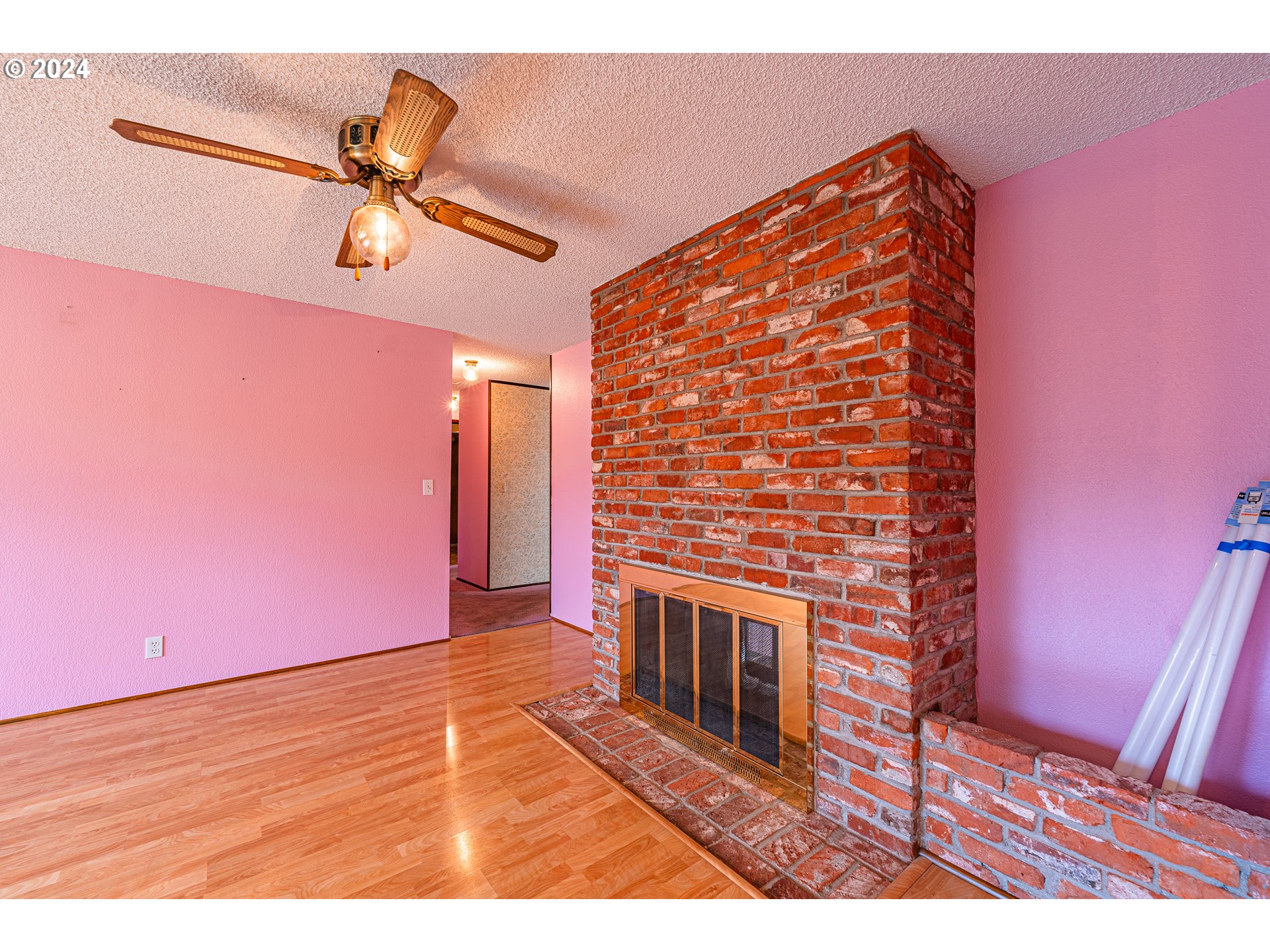 1063 65th Street Springfield, OR 97478 - Photo 8 of 23 a view of a livingroom with a fireplace and wooden floor