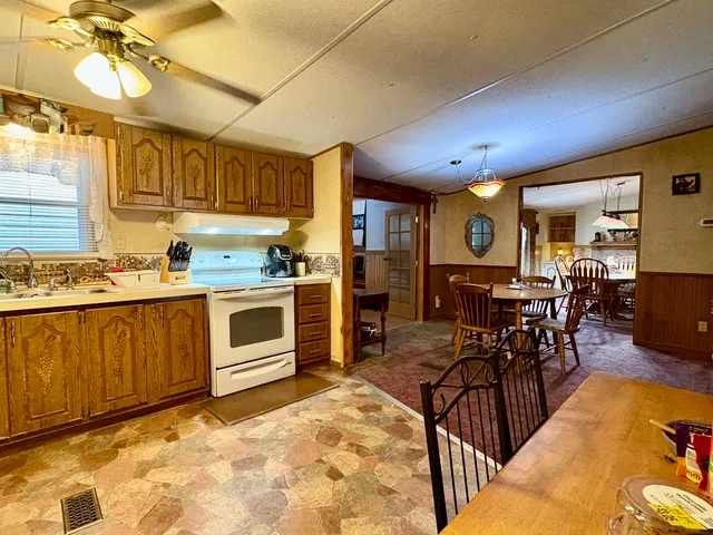 a living room with furniture a dining table and chairs