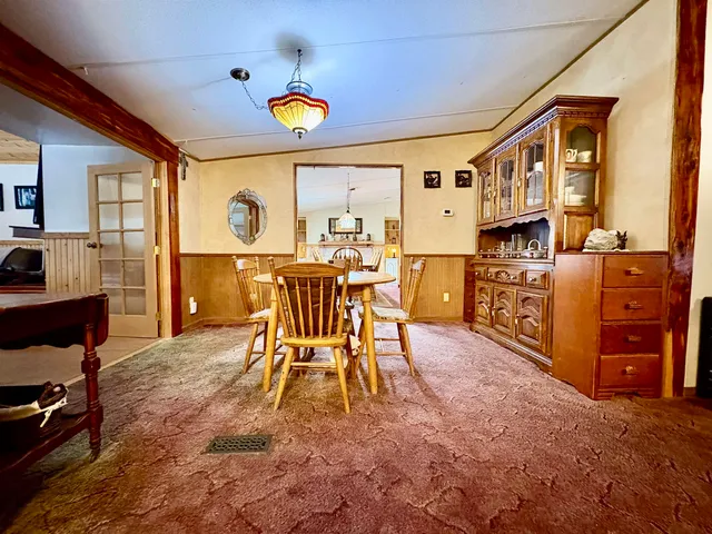a dining room with furniture a rug and wooden floor