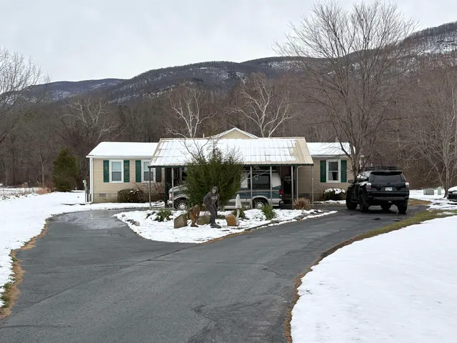 a patio with a table and chairs under an umbrella